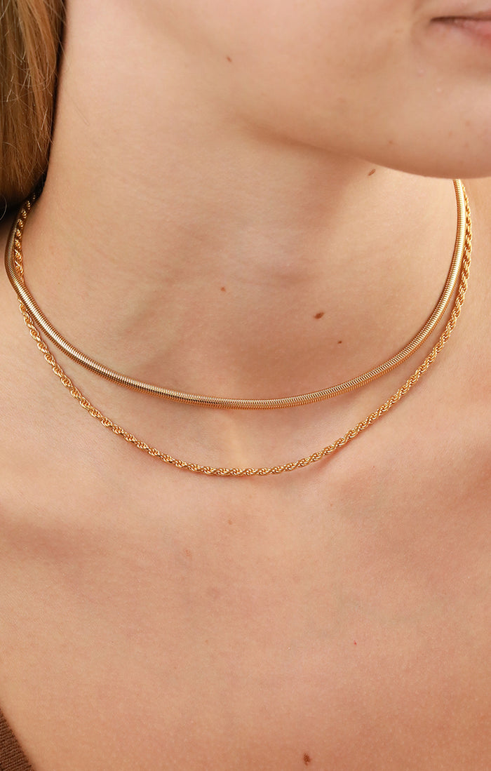 Woman wearing dainty silver and gold beaded choker necklaces